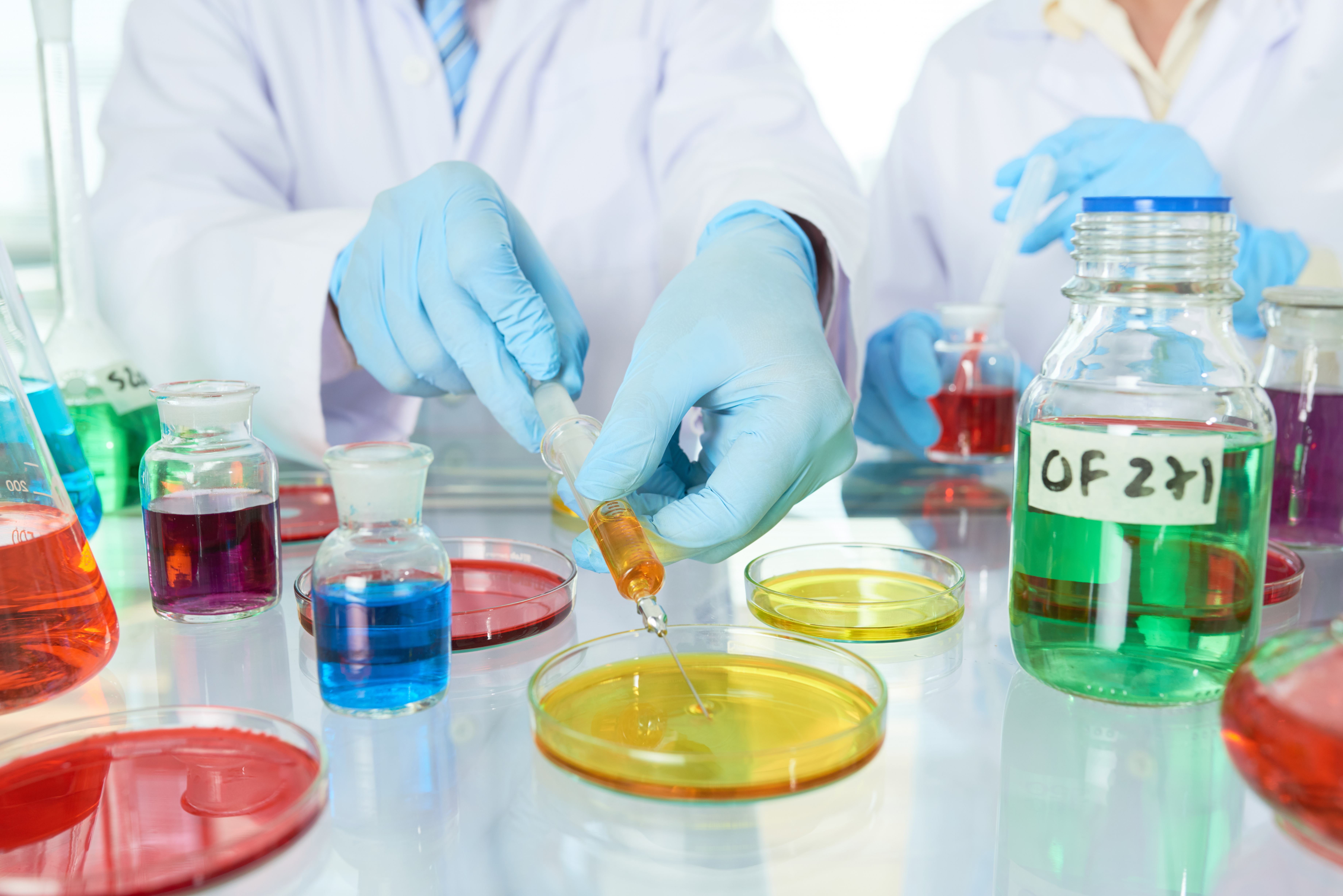 Lab technician using coalescing agents in paint formulations for even drying