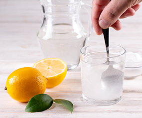 Glass of water with lemon representing hydrolyzed protein benefits for hair and skin care