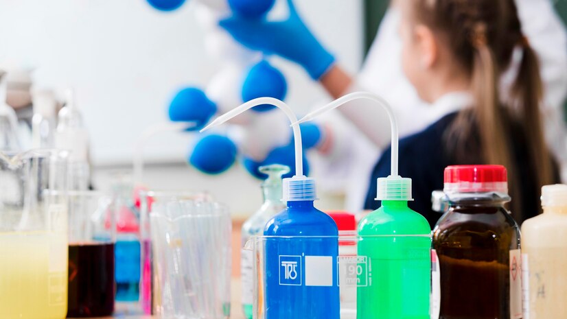 Laboratory bottles containing colorful chemical solvents used in extraction and refining processes