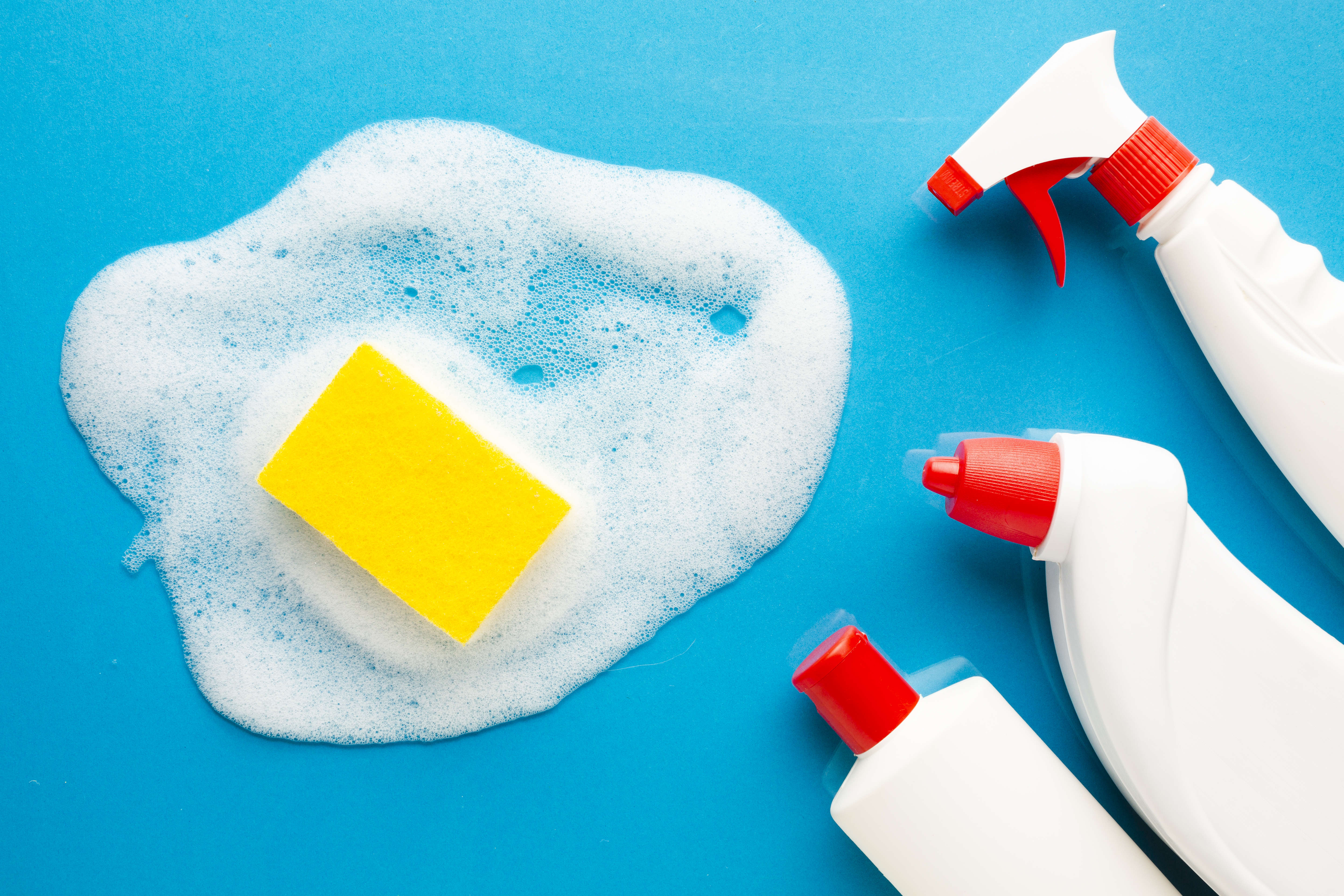 Cleaning agents with spray bottles and sponge for effective residue removal